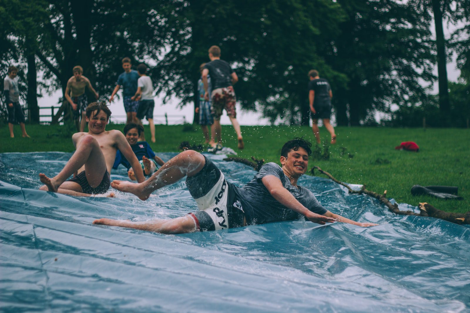 3 Questions to Ask Before Planning Your Next Youth Ministry Event in 2022-- Teens slip-n-sliding