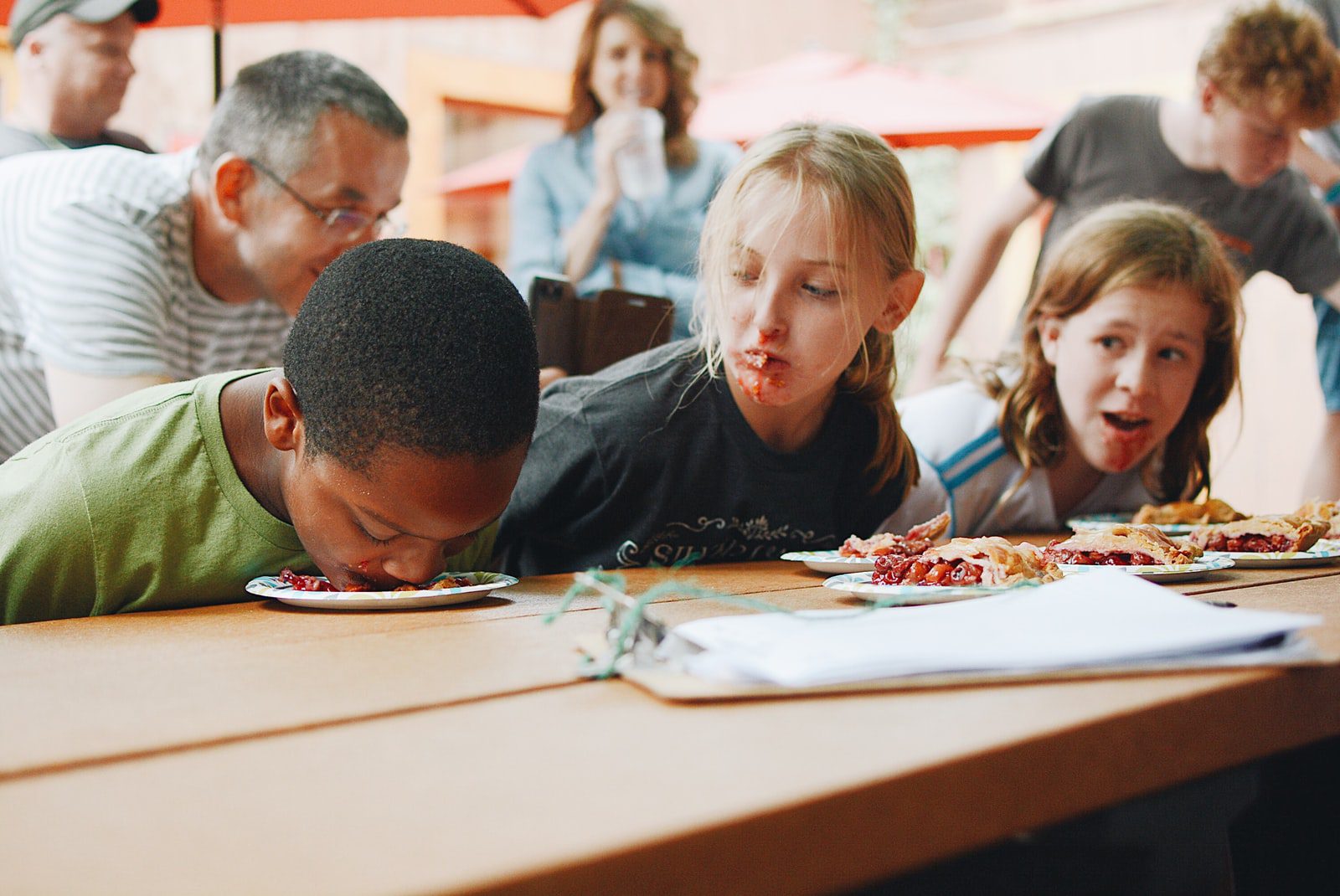 8 Essentials for an Awesome Kids Ministry Fall Kick-Off- Three Children at a Pie Eating Contest