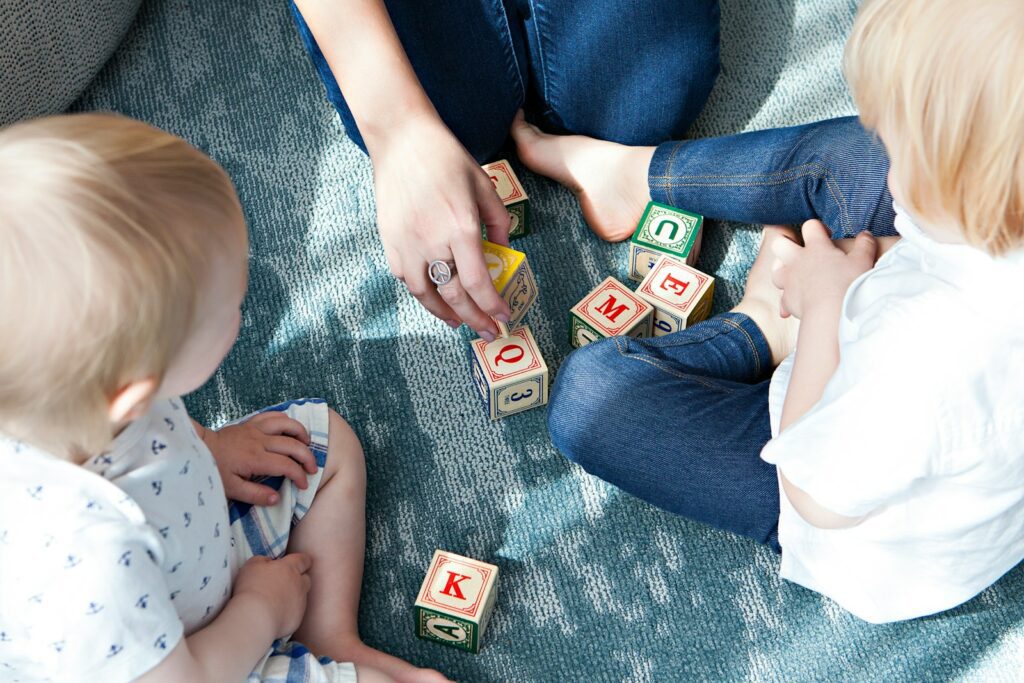 two toddler playing letter cubes for the article "5 First Steps to Creating an Inclusive Special Needs Ministry" by Ministry Architects Consultant Kerri-Ann Hayes