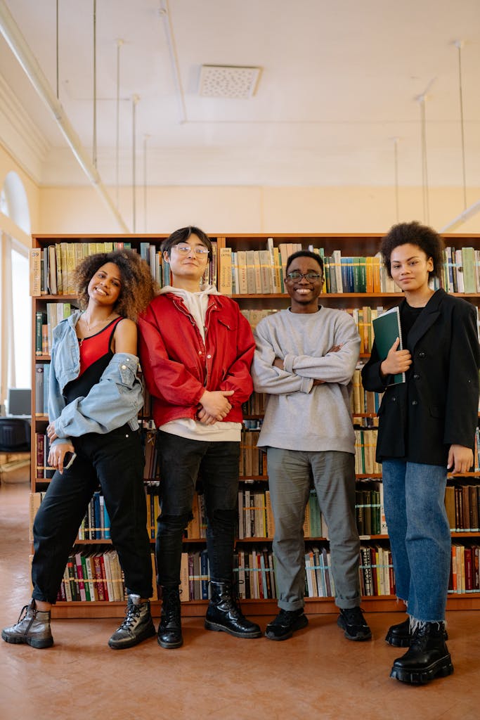 Young adults posing together in a library. Perfect for education and diversity themes.